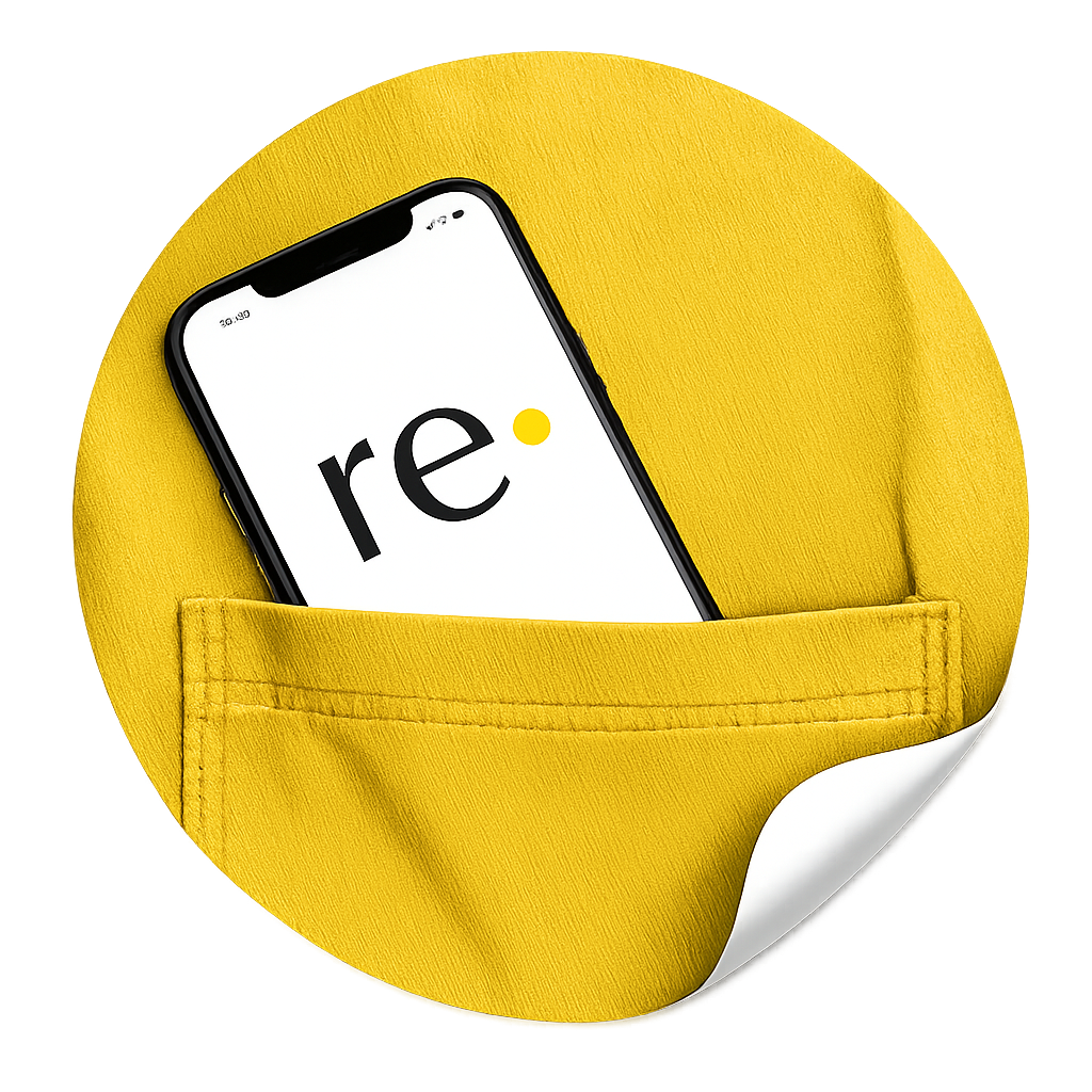 A hand holding a phone showing the Re· app beside folded pre-loved clothing